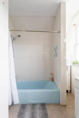 a bathroom with a blue tub in a room at Revamped 3BR Apt with Easy Check-In Family-Friendly in Bridgeport