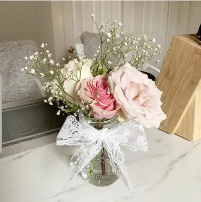 a vase filled with pink flowers on a table at Charming 2BR Getaway with Modern Comforts in Bridgeport