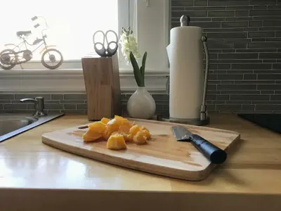a cutting board with a knife on a counter at Charming 2BR Getaway with Modern Comforts in Bridgeport