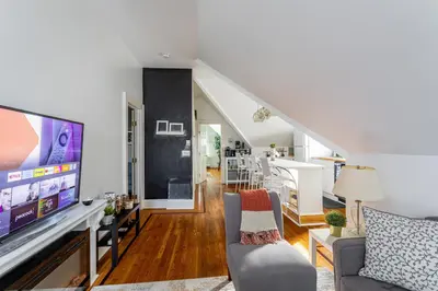 a living room with a large tv and a couch at Charming 2BR Getaway with Modern Comforts in Bridgeport