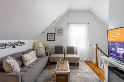 a living room with a couch and a tv at Charming 2BR Getaway with Modern Comforts in Bridgeport
