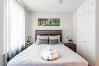 a bedroom with a bed with a towel on it at Sunny & Spacious 2BD 1BA WFH Apt-Huge Yard & Patio in Fairfield