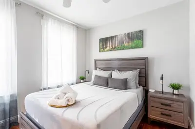a bedroom with a large white bed with a towel on it at Sunny & Spacious 2BD 1BA WFH Apt-Huge Yard & Patio in Fairfield