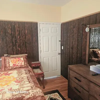a bedroom with a bed and a dresser and a door at HARPER AVE King Bed with Private Bathroom, FREE PARKING in Irvington