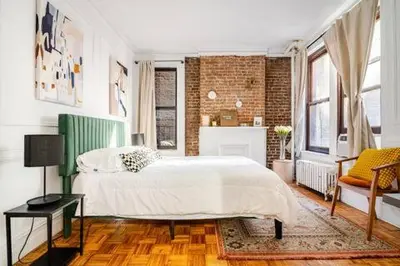 a bedroom with a bed and a brick wall at 89-2R 1BR Upper East Side in New York