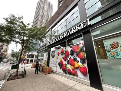 a store with a sign on the side of a street at 89-2R 1BR Upper East Side in New York