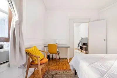 a bedroom with a bed and a table and chairs at 89-2R 1BR Upper East Side in New York