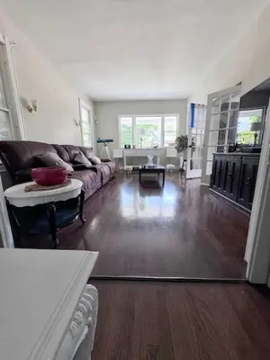 a living room with a couch and a table at Bloom Victorian Bed & Breakfast in South Orange