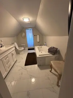 a bathroom with a sink and a tub and a toilet at Bloom Victorian Bed & Breakfast in South Orange