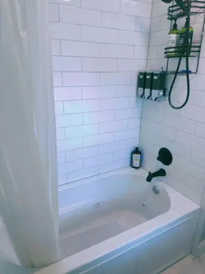 a white bath tub with a faucet in a bathroom at Bloom Victorian Bed & Breakfast in South Orange