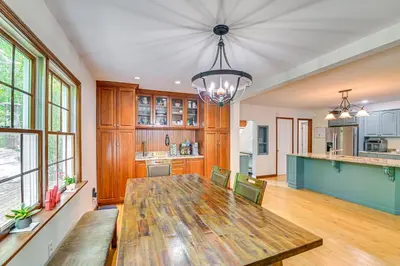 a kitchen and dining room with a wooden table at Charming Ballston Spa Home with Sauna and Private Pool in Ballston Spa