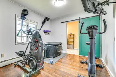 a room with a treadmill and a gym at Charming Ballston Spa Home with Sauna and Private Pool in Ballston Spa