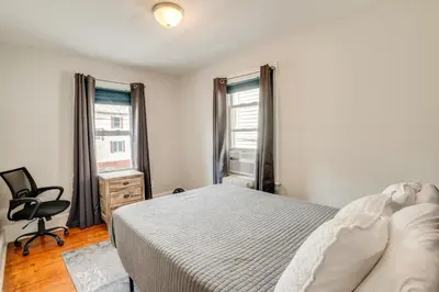 a bedroom with a bed and a desk and a chair at Hackensack Escape with Yard - 17 Mi to Times Square! in Hackensack