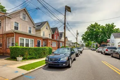 a car parked on the side of a street at Hackensack Escape with Yard - 17 Mi to Times Square! in Hackensack