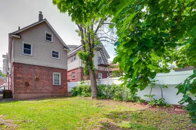 a house with a tree in a yard at Hackensack Escape with Yard - 17 Mi to Times Square! in Hackensack