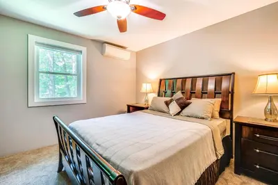a bedroom with a bed and a ceiling fan at Wilmington Retreat Near Trails, Skiing and Festivals in Wilmington