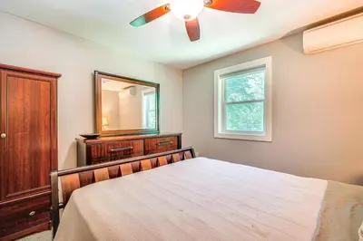 a bedroom with a bed and a mirror and a ceiling fan at Wilmington Retreat Near Trails, Skiing and Festivals in Wilmington