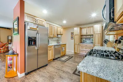 a kitchen with stainless steel appliances and wooden cabinets at Wilmington Retreat Near Trails, Skiing and Festivals in Wilmington