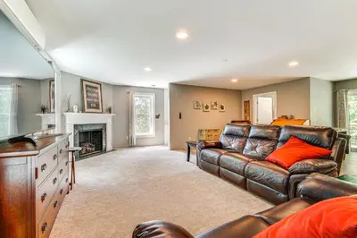 a living room with a leather couch and a fireplace at Wilmington Retreat Near Trails, Skiing and Festivals in Wilmington