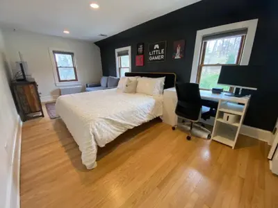 a bedroom with a bed and a desk with a computer at Enchanting Historic Home near West Point Beacon in Cornwall-on-Hudson