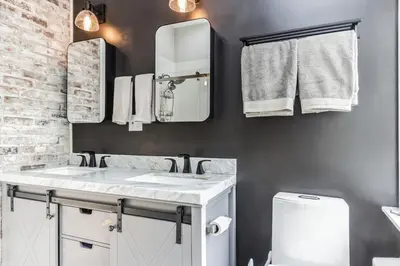 a bathroom with two sinks and mirrors and a toilet at Enchanting Historic Home near West Point Beacon in Cornwall-on-Hudson