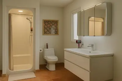 a bathroom with a toilet and a sink and a shower at NatureGlow Residence Stylish Contemporary Home in Harwinton