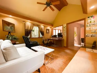 a living room with a white couch and a table at NatureGlow Residence Stylish Contemporary Home in Harwinton