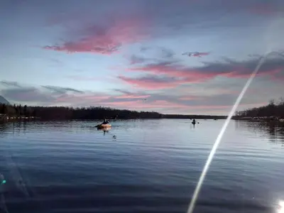 a group of people in a boat on a lake at Majestic Lake Front Chalet in Tobyhanna