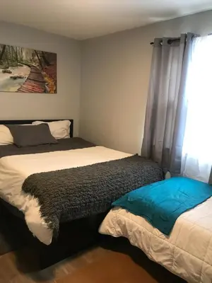a bedroom with two beds and a window at 30 mins to TIMES SQ!!!! in Corona