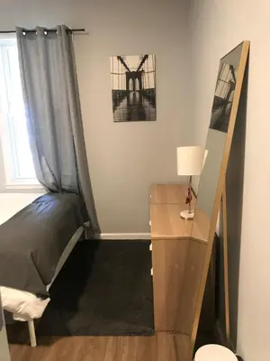 a room with a bed and a desk and a window at 30 mins to TIMES SQ!!!! in Corona
