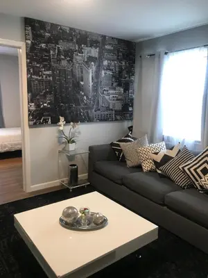 a living room with a couch and a coffee table at 30 mins to TIMES SQ!!!! in Corona
