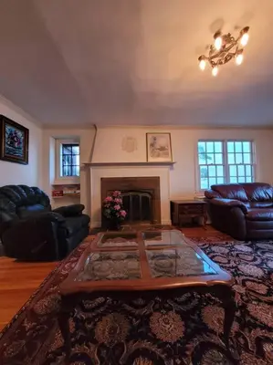 a living room with a coffee table and a fireplace at On the Water Spacious Comfortable Historic House in West Haven