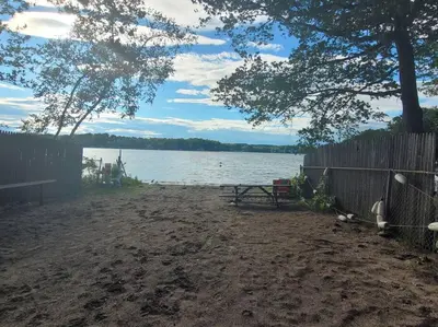 a picnic table on the shore of a lake at Lake Congamond Suffield House in Granby