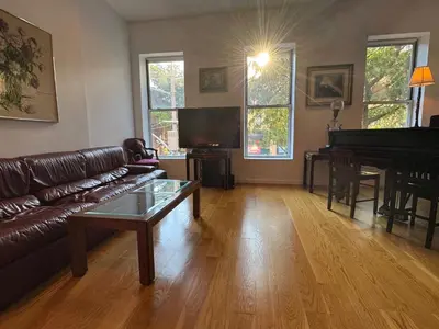 a living room with a couch and a piano at Large and Luxurious in Strivers Row in New York