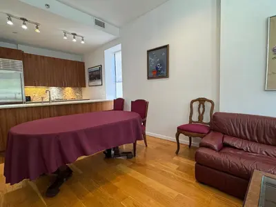 a living room with a table and a couch at Large and Luxurious in Strivers Row in New York
