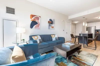 a living room with a blue couch and a table at Luxury Apt with Pool in Stamford