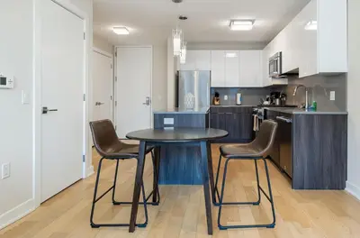 a kitchen with a table and chairs in it at Luxury Apt with Pool in Stamford