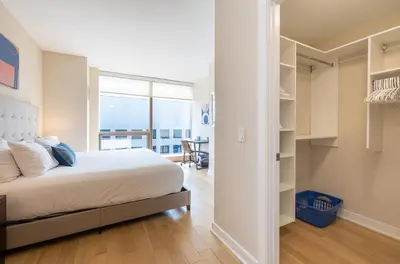 a bedroom with a bed and a walk in closet at Luxury Apt with Pool in Stamford