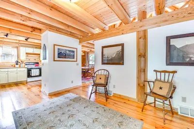 a kitchen and dining room with wooden ceilings at Lakefront Corinth Log Home Private Dock, Fire Pit in Lake Luzerne