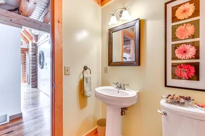 a bathroom with a sink and a mirror at Lakefront Corinth Log Home Private Dock, Fire Pit in Lake Luzerne