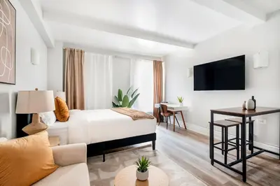 a hotel room with a bed and a couch at 73-410 Luxury 24 DM New Studio UWS Gym Laundry in New York