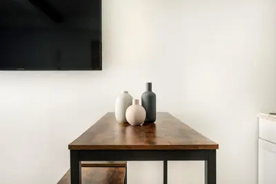 a table with three vases sitting on top of it at 73-410 Luxury 24 DM New Studio UWS Gym Laundry in New York
