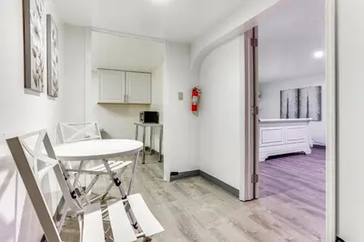 a living room with a table and a chair at Convenient Apt 2 Mi to Sprain Ridge Park! in Yonkers