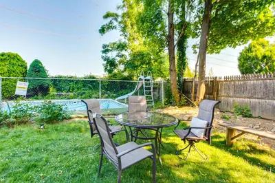 a patio with a table and chairs in the yard at Convenient Apt 2 Mi to Sprain Ridge Park! in Yonkers