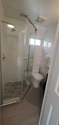 a bathroom with a shower and a toilet at Cozy apt 30mins from Times square!!! in Corona