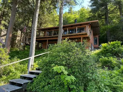 a house in the woods with stairs leading up to it at Lake Haven in Monterey