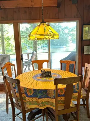 a dining room table with a yellow lamp and chairs at Lake Haven in Monterey