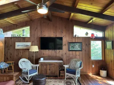 a living room with two chairs and a flat screen tv at Lake Haven in Monterey
