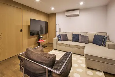 a living room with a couch and a flat screen tv at Modern 2 Bedroom Retreat in Downtown Manhattan in New York