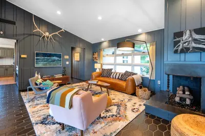 a living room with a couch and a fireplace at Hudson House in Newburgh